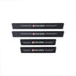 Set of four black carbon fibre Holden door sill protector stickers, two longer and two shorter, with Holden logo and white lines