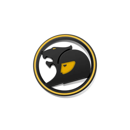 Black round 3D metal badge with yellow ring and yellow accent, stylised big cat design on a white background