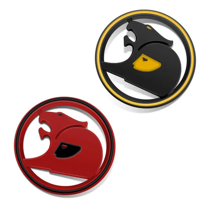 Two round 3D metal badges with a stylised big cat design, one black with a yellow ring and one red with a black ring
