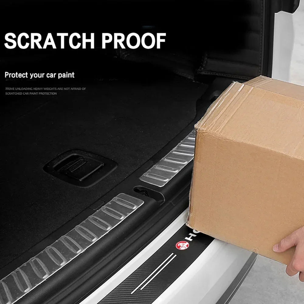 Holden carbon fibre protector sticker on a car boot edge while a hand slides a cardboard box in, with scratch proof text