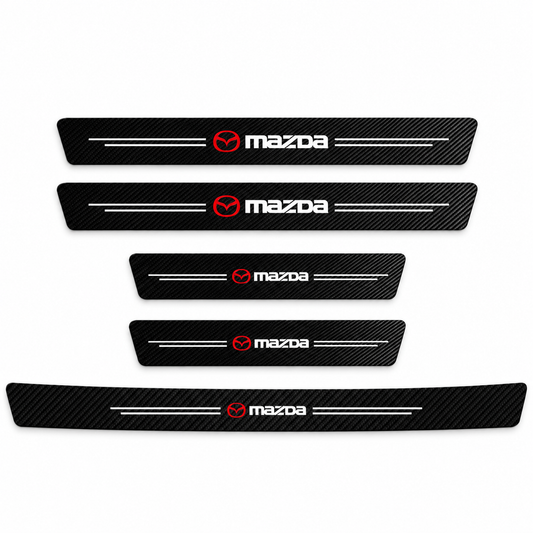 Black carbon fibre-look Mazda sill protector sticker applied on the rear boot sill of a car with the boot open